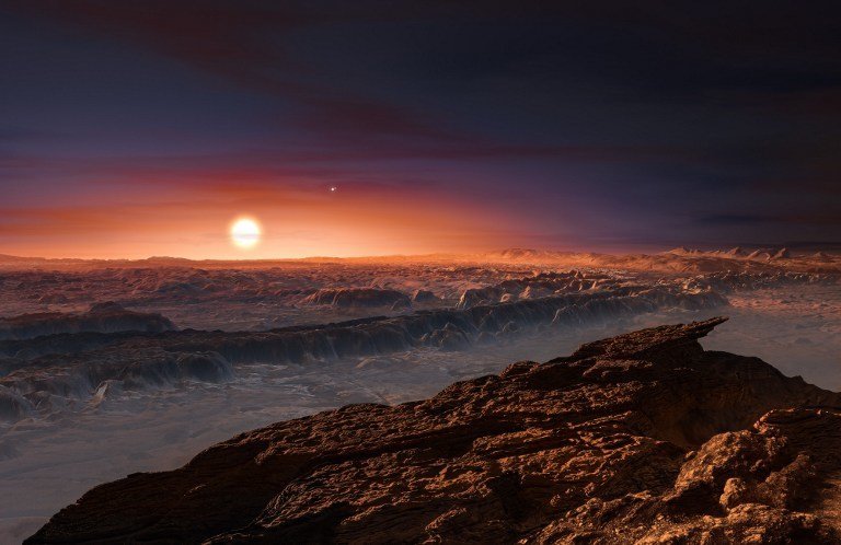 A hand out image made available by the European Southern Observatory on August 24 2016, shows an artist's impression of a view of the surface of the planet Proxima b orbiting the red dwarf star Proxima Centauri, the closest star to the Solar System. The double star Alpha Centauri AB also appears in the image to the upper-right of Proxima itself. Proxima b is a little more massive than the Earth and orbits in the habitable zone around Proxima Centauri, where the temperature is suitable for liquid water to exist on its surface.
 Scientists on August 24, 2016 announced the discovery of an Earth-sized planet orbiting the star nearest our Sun, opening up the glittering prospect of a habitable world that may one day be explored by robots. Named Proxima b, the planet is in a "temperate" zone compatible with the presence of liquid water -- a key ingredient for life. 
 / AFP PHOTO / EUROPEAN SOUTHERN OBSERVATORY / M. Kornmesser