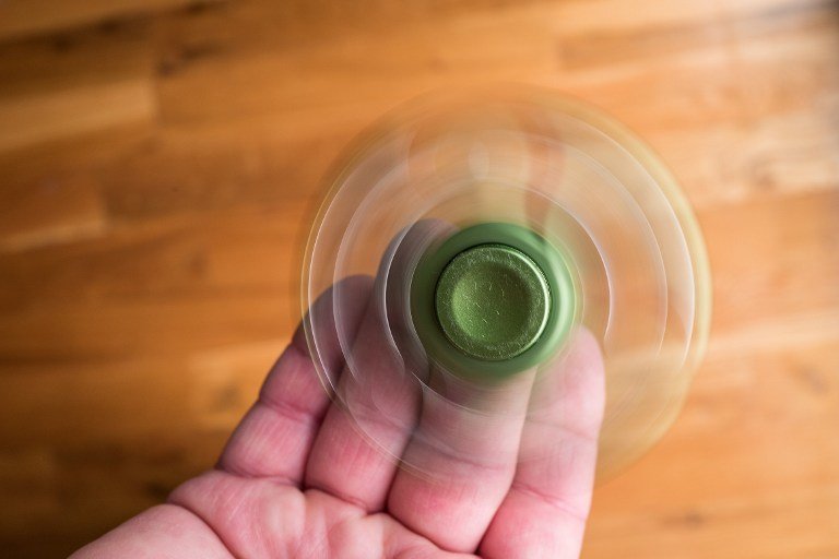 NEW YORK, NY - MAY 5: In this photo illustration, a man spins a fidget spinner, May 5, 2017 in the Brooklyn borough of New York City. Fidget spinners have become the latest toy sensation and some schools have banned them because they've become a distraction. (Photo Illustration by Drew Angerer/Getty Images)