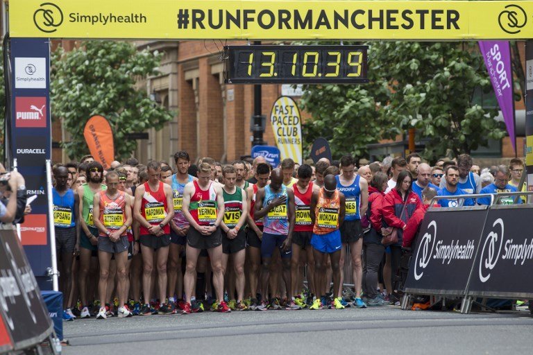 Elite runners observe a minute of silence for the victims of the Manchester Arena bombing before the start of the Great Manchester Run in Manchester, north west England on May 28, 2017. 
Britain police have released CCTV footage of Manchester bomber Salman Abedi on the night of the attack as thousands defied the terror threat to take part in the Great Manchester Run on Sunday. / AFP PHOTO / JON SUPER