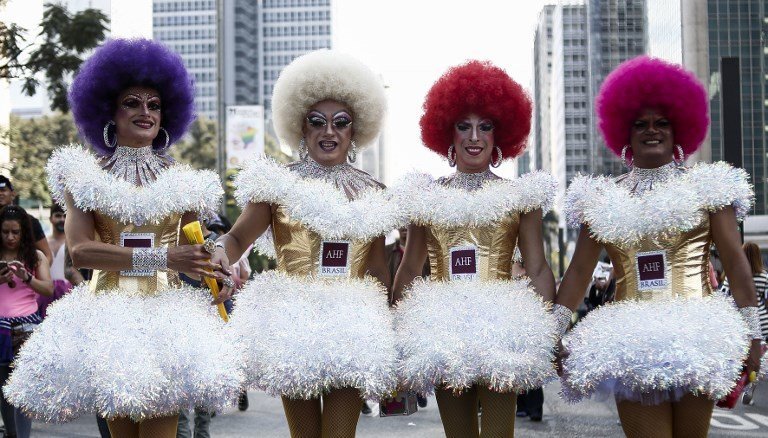Revelers take part in the 21st Gay Pride Parade, whose theme is "Secular State", in Sao Paulo, Brazil on June 18, 2017.  / AFP PHOTO / Miguel SCHINCARIOL