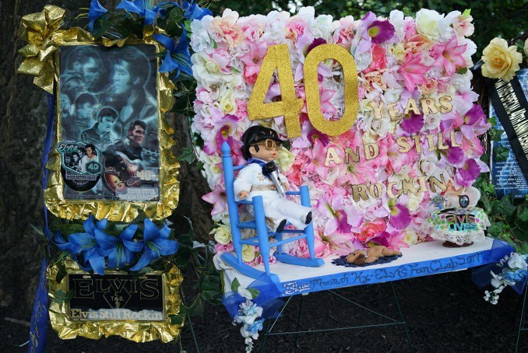 An August 12, 2017 photo shows tributes left by fans near the gravesite of Elvis Presely at his Graceland mansion in Memphis, Tennessee.
Forty years after his tragic death at age 42, more than 600,000 fans visit each year, floral tributes still gather from around the world in the Meditation Garden, where the King of rock 'n' roll his buried at his Graceland home in Memphis. / AFP PHOTO / MANDEL NGAN / With AFP Story by Jennie MATTHEW: 'Gift from God' Elvis the semi-divine myth 40 years on  