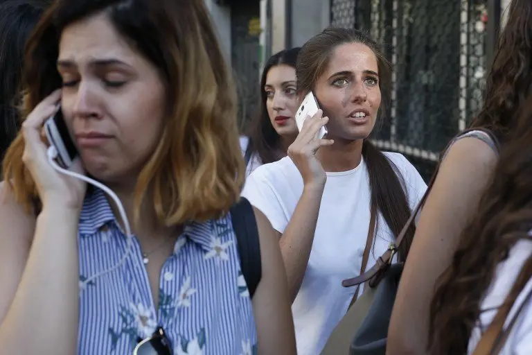 People phone to relatives or friends after a van ploughed into the crowd, killing one person and injuring several others on the Rambla in Barcelona on August 17, 2017.
Police in Barcelona said they were dealing with a "terrorist attack" after a vehicle ploughed into a crowd of pedestrians on the city's famous Las Ramblas boulevard on August 17, 2017. Police were clearing the area after the incident, which has left a number of people injured. / AFP PHOTO / Pau Barrena
