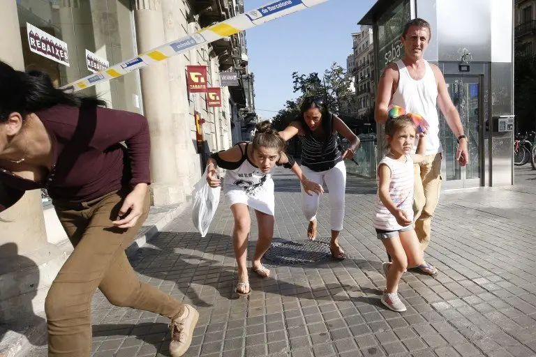 People leave a cordoned off area after a van ploughed into the crowd, killing one person and injuring several others on the Rambla in Barcelona on August 17, 2017.
Police in Barcelona said they were dealing with a "terrorist attack" after a vehicle ploughed into a crowd of pedestrians on the city's famous Las Ramblas boulevard on August 17, 2017. Police were clearing the area after the incident, which has left a number of people injured. / AFP PHOTO / Pau Barrena