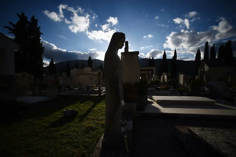 A statue of the Virgin Mary stands in the damaged cemetery of Norcia, on November 2, 2016 three days after a 6.5 magnitude earthquake hit central Italy. Some 3,000 farms in the earthquake-hit region of central Italy are in danger of being abandoned and need urgent help, the main Italian farming union said on Tuesday. Farming is the primary industry in the mountainous region where tens of thousands of livestock are affected, according to Coldiretti.
 / AFP PHOTO / FILIPPO MONTEFORTE