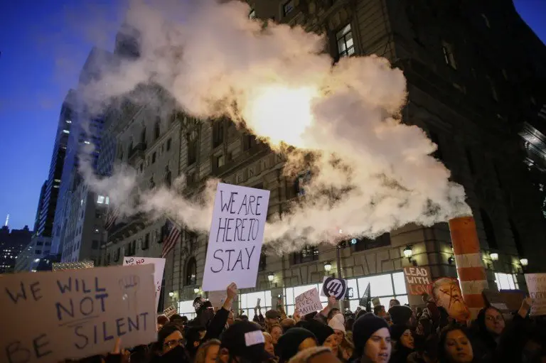 Demonstrators protest against US President-elect Donald Trump in front of Trump Tower on November 12, 2016 in New York. 
Americans spilled into the streets Saturday for a new day of protests against Donald Trump, even as the president-elect appeared to back away from the fiery rhetoric that propelled him to the White House. / AFP PHOTO / KENA BETANCUR