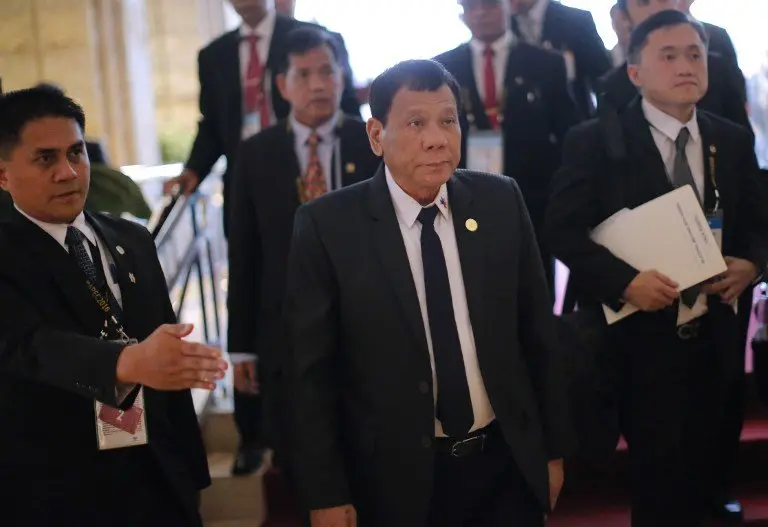 Philippine President Rodrigo Duterte (C) arrives at a hotel to attend a bilateral meeting with Russia's President Vladimir Putin on the sidelines of the Asia-Pacific Economic Cooperation Summit (APEC) in Lima on November 19, 2016. / AFP PHOTO / LUKA GONZALES