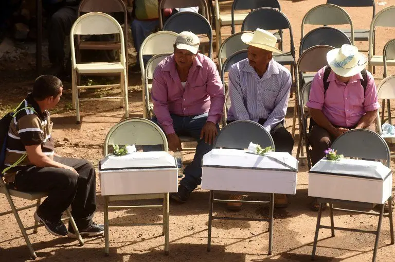 Relatives and villagers hold a funeral to bury the exhumed and identified remains of 21 people killed during the El Mozote massacre, during the commemoration the 1981 killings, in El Mozote, 200 km east of San Salvador, on December 10, 2016.
In December 1981, during the 1980-1992 civil war in El Salvador, members of the US-trained Salvadoran elite Atlacatl battalion killed more than a thousand villagers during counterinsurgency operations in El Mozote and neighbouring villages, in what is known as the El Mozote massacre.  / AFP PHOTO / Marvin RECINOS