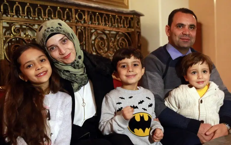 Syrian girl Bana al-Abed (L), known as Aleppo's tweeting girl, poses with her family, her mother Fatemah, her father Ghassan and her brothers Nour (C) and Laith (R) during an interview in Ankara, Turkey, on December 22, 2016. 
The young Syrian girl was one of thousands of people evacuated from once rebel-held areas of Aleppo in the last days under a deal brokered by Turkey and Russia. She was evacuated on Monday and Turkish officials promised then she would come to Turkey with her family. But it was not clear when she had crossed over. / AFP PHOTO / ADEM ALTAN