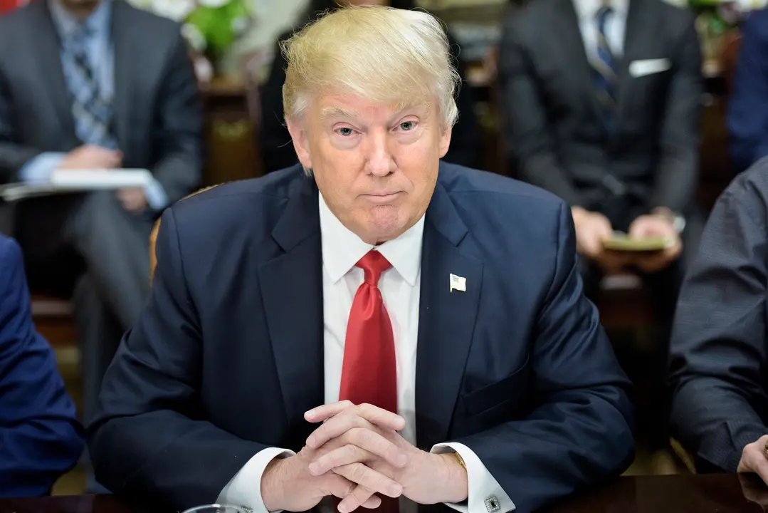 US President Donald Trump waits for a lunch meeting with Harley Davidson executives and union representatives in the Roosevelt Room of the White House February 2, 2017 in Washington, DC. / AFP PHOTO / Brendan Smialowski