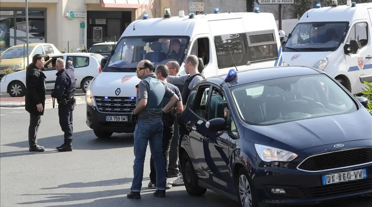 Policemen stand near police vehicles in the southern French town of Grasse  on March 16  2017 following a shooting in the Tocqueville high school that left two people injured  At least two people were injured in a shooting at a high school in the southern French town of Grasse on March 16  2017 which saw the head teacher targeted  police and local authorities said  One 17-year-old pupil armed with a rifle  two handguns and two grenades was arrested after the shooting at the Tocqueville high school  a police source told AFP  asking not to be named     AFP PHOTO   Valery HACHE