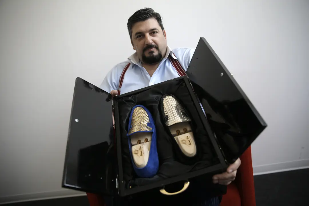 El dise&ntilde;ador italiano Antonio Vietri muestra los zapatos con piezas de oro.