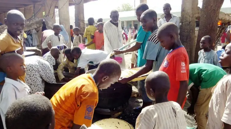 <p>Unos niños reciben comida en el campo de desplazados de Maiduguri, Nigeria, el 19 de mayo de 2016</p>