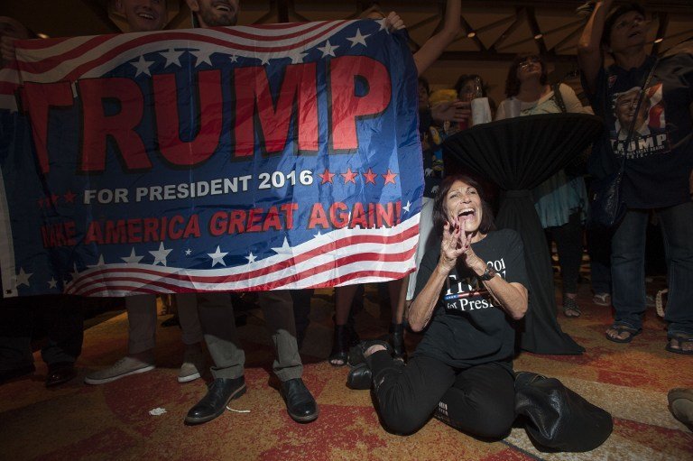 Supporter of Republican candidate Donald Trump, Robin Labani, 50, of Gilbert, Arizona cheers as election results come in during a viewing party at a hotel in downtown Phoenix, Arizona on November 8, 2016.
Millions of Americans voted November 8th for their new leader in a historic election that will either elevate Democrat Hillary Clinton as their first woman president or hand power to maverick populist Donald Trump. / AFP PHOTO / Laura Segall