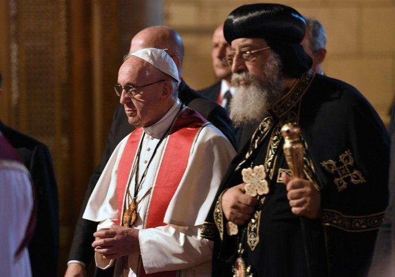 Pope Francis (L) walks alongside Coptic Pope Tawadros II (R) during a visit at the Saint Peter and Saint Paul church in Cairo, which was target by a suicide bomb attack that killed 29 people last December, on April 28, 2017
Francis, who started a two-day visit, has said he hoped his trip would contribute to dialogue with Muslims and show support for Egypt's Coptic Christians.  / AFP PHOTO / Andreas SOLARO