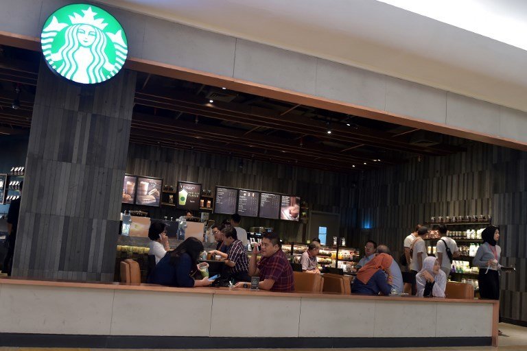 This photo taken on July 4, 2017 shows customers sitting inside a Starbucks cafe at a shopping mall in Jakarta.
Muslims in Indonesia and Malaysia were urged to boycott Starbucks on July 4 by major Islamic groups accusing the coffee chain of being pro-gay rights, as concerns grow over rising religious conservatism in both nations.  / AFP PHOTO / Adek BERRY
