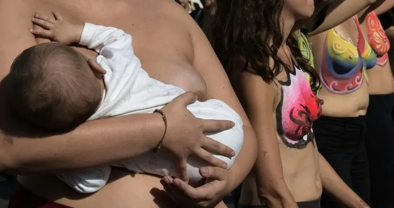 <p>Una mujer alimenta a su bebé durante una manifestación en Buenos Aires el 14 de mayo de 2015</p>