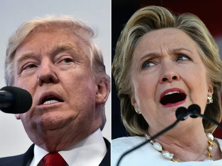 (COMBO) This combination of pictures created on November 04, 2016 shows
US Republican presidential nominee Donald Trump in Atkinson, New Hampshire on November 4, 2016 and US Democratic presidential nominee Hillary Clinton in Dade City, Florida, on November 1, 2016.
With only 4 days to go until Election Day, Hillary Clinton and Donald Trump were barnstorming battleground states.
/ AFP PHOTO / MANDEL NGAN AND JEWEL SAMAD