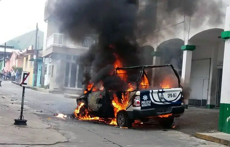 A police car burns in flames at Catemaco community in Veracruz, Mexico on November 12, 2016, during a protest after priest Jose Luis Sanchez disappeared.
Furious residents of Catemaco municipality sacked the city hall and burnt a police car as they protested for second consecutive day for the disappearance of a priest, who was allegedly kidnapped. / AFP PHOTO / EDUARDO MURILLO