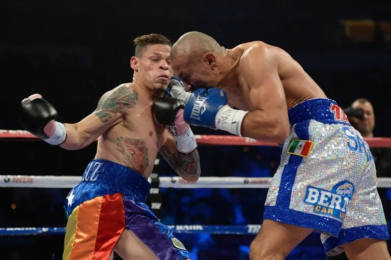 LAS VEGAS, NV - OCTOBER 12: Orlando Salido (R) lands a right to the head of Orlando Cruz during their WBO featherweight championship bout at the Thomas & Mack Center on October 12, 2013 in Las Vegas, Nevada.   Jeff Bottari/Getty Images/AFP