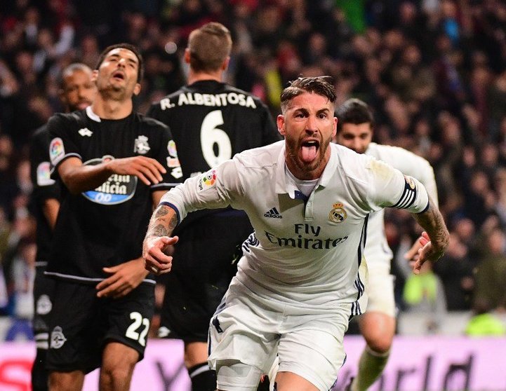 Real Madrid's defender Sergio Ramos celebrates after scoring during the Spanish league football match Real Madrid CF vs RC Deportivo at the Santiago Bernabeu stadium in Madrid on December 10, 2016. / AFP PHOTO / PIERRE-PHILIPPE MARCOU