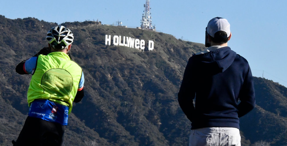 The famous Hollywood sign reads "Hollyweed" after it was vandalized, January 1, 2017.  
Police said unidentified thrill-seekers had climbed up and arranged tarps over the two letter "O's" to make them look like "E's," CBS affiliate KCAL reported. Each letter is 45 feet (13.7 meters) high, so the feat would have required not just bravado but considerable athleticism. 
 / AFP PHOTO / Gene Blevins