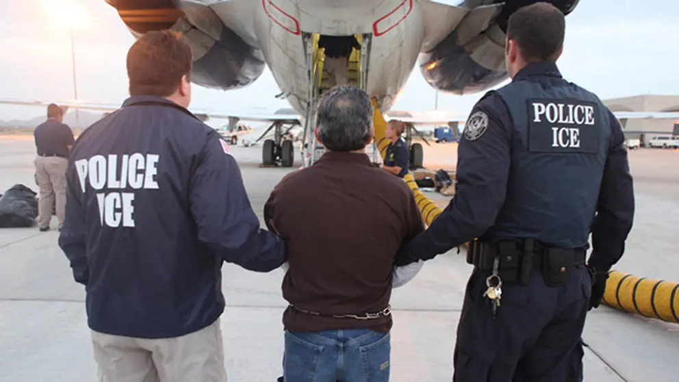 This image provided by U.S. Immigration and Customs Enforcement (ICE) shows Pedro Pimentel Rios being led to a  government-chartered plane to Guatemala at an ICE airport in Mesa, Ariz. on Tuesday, July 12, 2011. Pimentel, a former instructor at the Guatemalan training school for a force known as the "kaibiles," was ordered deported from the United States in May when an immigration judge rejected his bid for asylum. (AP Photo/ICE)