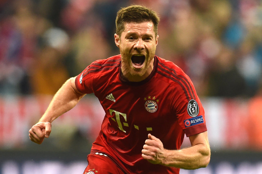 (FILES) This file photo taken on May 03, 2016 shows Bayern Munich's Spanish midfielder Xabi Alonso celebrating scoring during the UEFA Champions League semi-final, second-leg football match between FC Bayern Munich and Atletico Madrid in Munich, southern Germany.
Bayern Munich's Spanish midfielder Xabi Alonso announced on March 9, 2017 thta he will end his football career at the end of the current season. / AFP PHOTO / Christof Stache