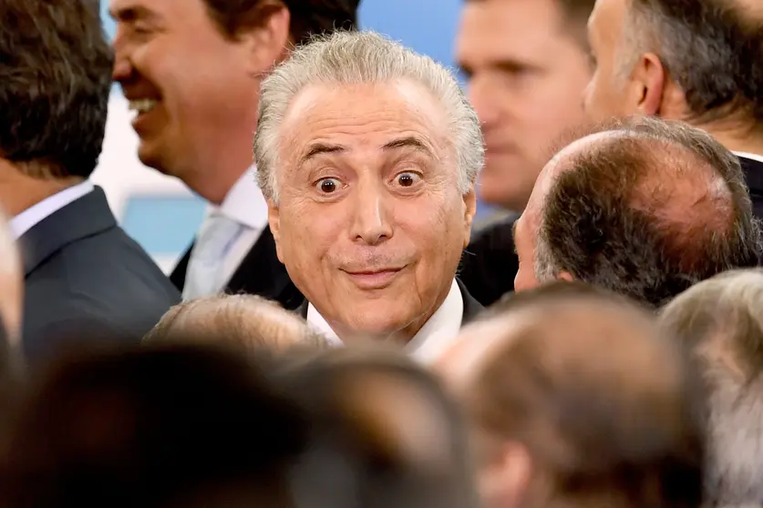 Brazilian President Michel Temer gestures during the swearing in ceremony of his new ministers of Justice and Foreign Affairs, at Planalto Palace in Brasilia, on March 7, 2017. / AFP PHOTO / EVARISTO SA