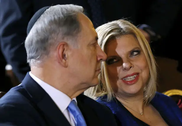 FILE - In this Dec. 1, 2013 file photo, Prime Minister Benjamin Netanyahu listens to his wife Sara during a meeting with the Roman Jewish Community at the Great Synagogue in Rome. With Israeli elections looming and the region in turmoil, Netanyahu found himself once more enmeshed in a gossipy scandal on Tuesday: Israel's government watchdog released a report into alleged financial malfeasance at the prime minister's residence, while his wife faced criticism for pettiness and possible security breaches after complaining in a video about the shabbiness of the kitchen at their official Jerusalem residence. (AP Photo/Riccardo De Luca, File)