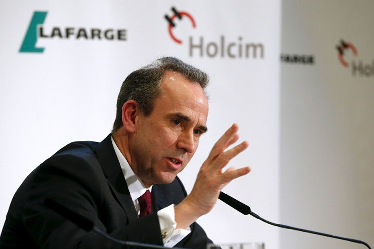Future CEO Eric Olsen of the new merged entity LafargeHolcim smiles addresses a news conference in Zurich April 9, 2015. Cement maker Holcim has backed Olsen as chief executive following the Swiss firm's planned merger with French peer Lafarge. REUTERS/Arnd Wiegmann - RTR4WM7F
