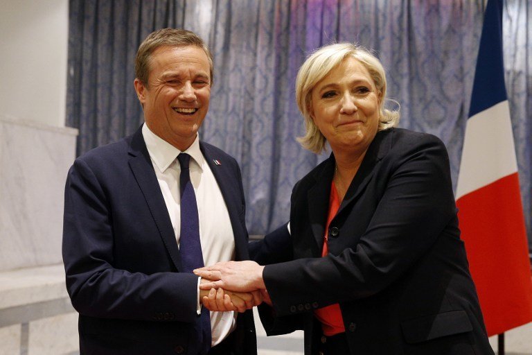 Former French presidential election candidate for the right-wing Debout la France (DLF) party Nicolas Dupont-Aignan (L) and French presidential election candidate for the far-right Front National (FN) party Marine Le Pen, shake hands at the end of a joint statement at FN headquarters in Paris, on April 29, 2017.
Dupont-Aignan, who arrived on the sixth position with 4.7% of the votes during the first round of the presidential election, announced on April 28, 2017 that "he endorses" Marine Le Pen for the second round of the election. The candidate of the FN declared that she will appoint Dupont-Aignan as Prime minister if she will be elected. / AFP PHOTO / GEOFFROY VAN DER HASSELT