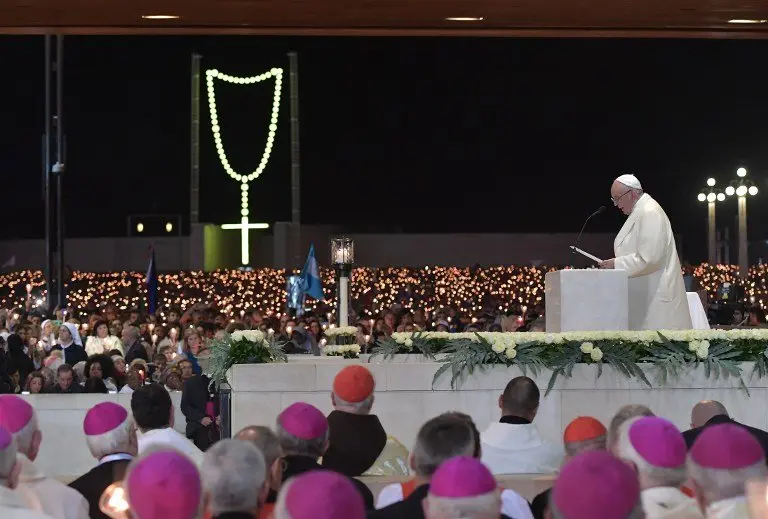 Pope Francis (R) speaks during the Blessing for the Candles from the Chapel of the Apparitions, in Fatima on May 12, 2017.
Two of the three child shepherds who reported apparitions of the Virgin Mary in Fatima, Portugal, one century ago, will be declared saints on May 13, 2017 by Pope Francis.
The canonisation of Jacinta and Francisco Marto will take place during the Argentinian pontiff's visit to a Catholic shrine visited by millions of pilgrims every year. / AFP PHOTO / Tiziana FABI