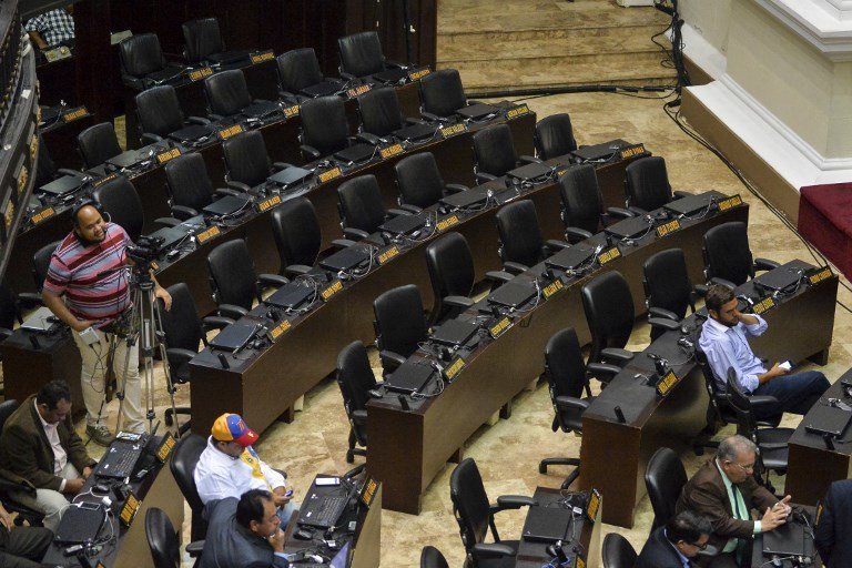 Picture of the empty chairs of deputies of the ruling Venezuela's United Socialist Party (PSUV), taken during a National Assembly session in Caracas, on May 23, 2017.
Venezuelan President Nicolas Maduro formally launched moves to rewrite the constitution, defying opponents who accuse him of clinging to power in a political crisis that has sparked deadly unrest. The opposition-controlled National Assembly promptly rejected Maduro's plan. / AFP PHOTO / LUIS ROBAYO