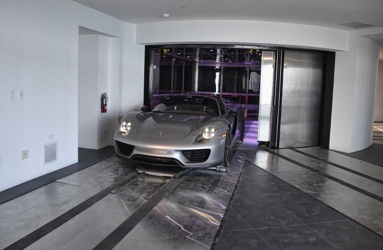 A Porsche arrives in a condo in the automated car elevator in the Porsche Design Tower on Sunny Isles Beach, Florida, on May 9, 2017.

The luxury condominiums are the only one of their kind with a patented car elevator known as the Dezervator, named for Developer Gil Dezer, allowing you to park you vehicle inside your home. / AFP PHOTO / RHONA WISE