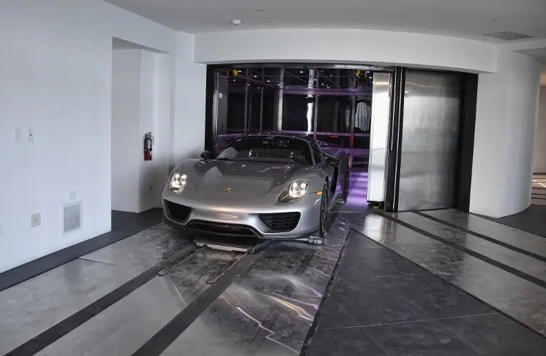 A Porsche arrives in a condo in the automated car elevator in the Porsche Design Tower on Sunny Isles Beach, Florida, on May 9, 2017.
The luxury condominiums are the only one of their kind with a patented car elevator known as the Dezervator, named for Developer Gil Dezer, allowing you to park you vehicle inside your home. / AFP PHOTO / RHONA WISE
