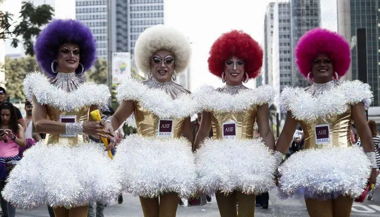 Revelers take part in the 21st Gay Pride Parade, whose theme is "Secular State", in Sao Paulo, Brazil on June 18, 2017. / AFP PHOTO / Miguel SCHINCARIOL
