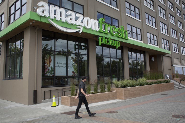 SEATTLE, WA - JUNE 16: A man walks past an AmazonFresh Pickup location on June 16, 2017 in Seattle, Washington. Amazon announced that it will buy Whole Foods Market, Inc. for over $13 billion dollars.   David Ryder/Getty Images/AFP