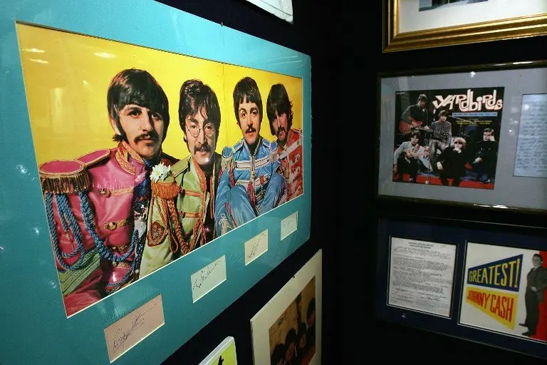 Beatles memorabilia stands on display at Christie's 10 December 2004 in New York City. Christie's, in a partnership with Julien's, will hold a Rock & Roll and Entertainment Memorabilia auction Friday, 17 December 2004. The sale, which will include such items as guitars owned by Beatle George Harrison, an Academy Award from 1941 for Best Picture, interview tapes of John Lennon, letters from Kurt Cobain to Courtney Love and numerous Elvis memorabilia, is expected to realize in the region of $3 million. (Photo by Spencer Platt/Getty Images/AFP) FOR NEWSPAPERS AND TV USE ONLY -- MORE IMAGES AVAILABLE ON IMAGEFORUM