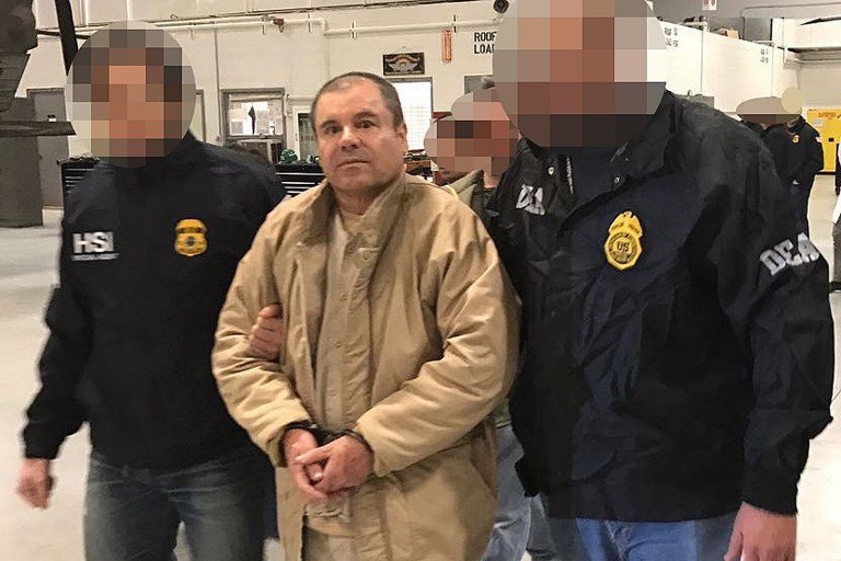 This handout picture released by the Mexican Interior Ministry on January 19, 2017 shows Joaquin Guzman Loera aka "El Chapo" Guzman (C) escorted in Ciudad Juarez by the Mexican police as he is extradited to the United States. 
Mexican drug baron Joaquin "El Chapo" Guzman, one of the world's most notorious criminals, was extradited to the United States on January 19, 2017 to face charges. - Pixelation of faces was done by the Mexican Interior Ministry / AFP PHOTO / INTERIOR MINISTRY OF MEXICO / HO /   RESTRICTED TO EDITORIAL USE-MANDATORY CREDIT "AFP PHOTO/INTERIOR MINISTRY OF MEXICO" NO MARKETING NO ADVERTISING CAMPAIGNS-DISTRIBUTED AS A SERVICE TO CLIENTS-XGTY