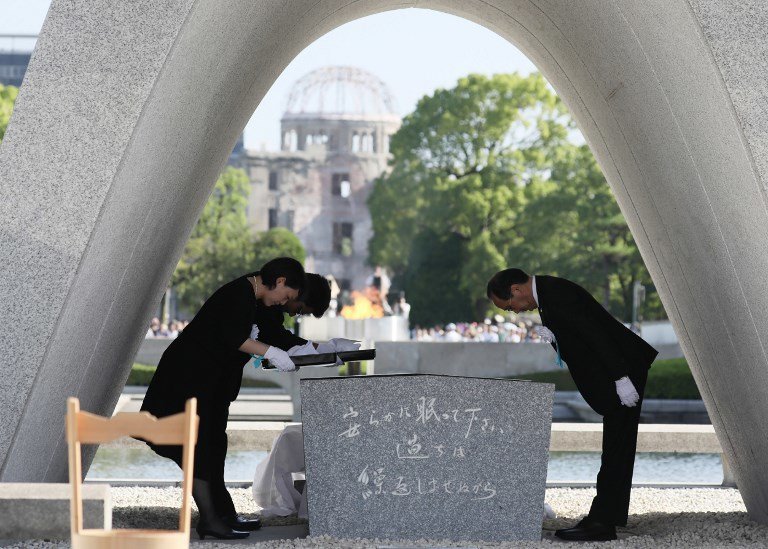 Hiroshima Mayor Kazumi Matsui (R) offers a new list of A-bomb dead, people who died since last year's anniversary from the side effects of radiation, during the 72nd anniversary memorial service for the atomic bomb victims at the Peace Memorial Park in Hiroshima on August 6, 2017.
A US B-29 plane dropped a bomb over the city at 8:15am on August 6, 1945, marking the first use of an atomic weapon which ultimately claimed the lives of some 140,000 people. / AFP PHOTO / JIJI PRESS / STR / Japan OUT