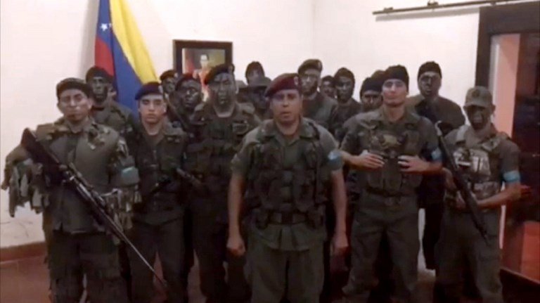 This TV grab taken from a video posted on social media on August 6, 2017 shows a man who allegedly presented himself as army captain Juan Caguaripano at an army base used by the National Bolivarian Armed Forces (FANB in Spanish) in Venezuela's third city of Valencia.
In the video posted online, a man presenting himself as an army captain declared a "legitimate rebellion... to reject the murderous tyranny of Nicolas Maduro" and demanded a transitional government and "free elections." After the video surfaced, military chiefs said troops had put down the "terrorist" attack. / AFP PHOTO / HANDOUT / HO / RESTRICTED TO EDITORIAL USE - MANDATORY CREDIT "AFP PHOTO / HO" - NO MARKETING NO ADVERTISING CAMPAIGNS - DISTRIBUTED AS A SERVICE TO CLIENTS

