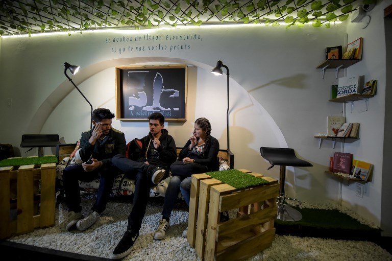 Deaf customers communicate through sign language at the "Sin Palabras" (Without Words) coffee bar in Bogota on July 19 , 2017
With menus with vignettes depicting sign language, lamps to call the waiter and the floor that vibrates according to the rhythm of music, the cafe  seeks to impose itself in the city as the first one of its kind for the deaf population. / AFP PHOTO / Raul Arboleda / TO GO WITH AFP STORY by Rodrigo ALMONACID