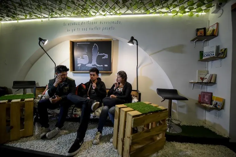 Deaf customers communicate through sign language at the "Sin Palabras" (Without Words) coffee bar in Bogota on July 19 , 2017
With menus with vignettes depicting sign language, lamps to call the waiter and the floor that vibrates according to the rhythm of music, the cafe seeks to impose itself in the city as the first one of its kind for the deaf population. / AFP PHOTO / Raul Arboleda / TO GO WITH AFP STORY by Rodrigo ALMONACID