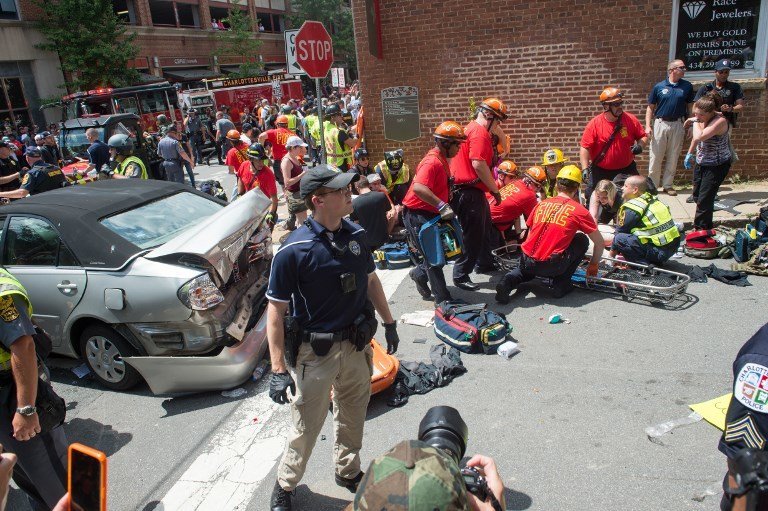(FILES) This file photo taken on August 12, 2017 shows a woman  receiving first-aid after a car accident ran into a crowd of protesters in Charlottesville, Virginia.
A suspected white supremacist's attack on a crowd of protesters using his car as a battering ram fits the definition of domestic terrorism, US Attorney General Jeff Sessions said August 14, 2017. A woman was killed and 19 people were injured when the car plowed into a crowd of people Saturday in Charlottesville, Virginia after a violent rally by neo-Nazis and white supremacists protesting the removal of a Confederate statue.The vehicle attack "does meet the definition of domestic terrorism in our statute," Sessions said in an interview on ABC's Good Morning America program.

 / AFP PHOTO / PAUL J. RICHARDS