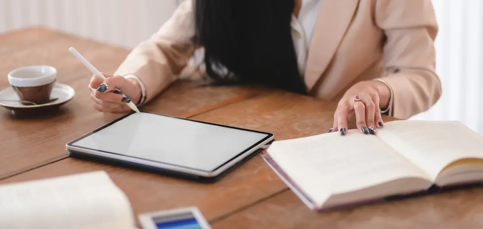 photo-of-woman-using-tablet-while-holding-book-3803224