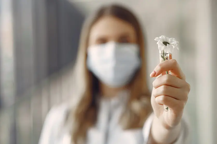 Medical student at the hall. Woman in a white uniform. Doctor in masks. Coronavirus theme.