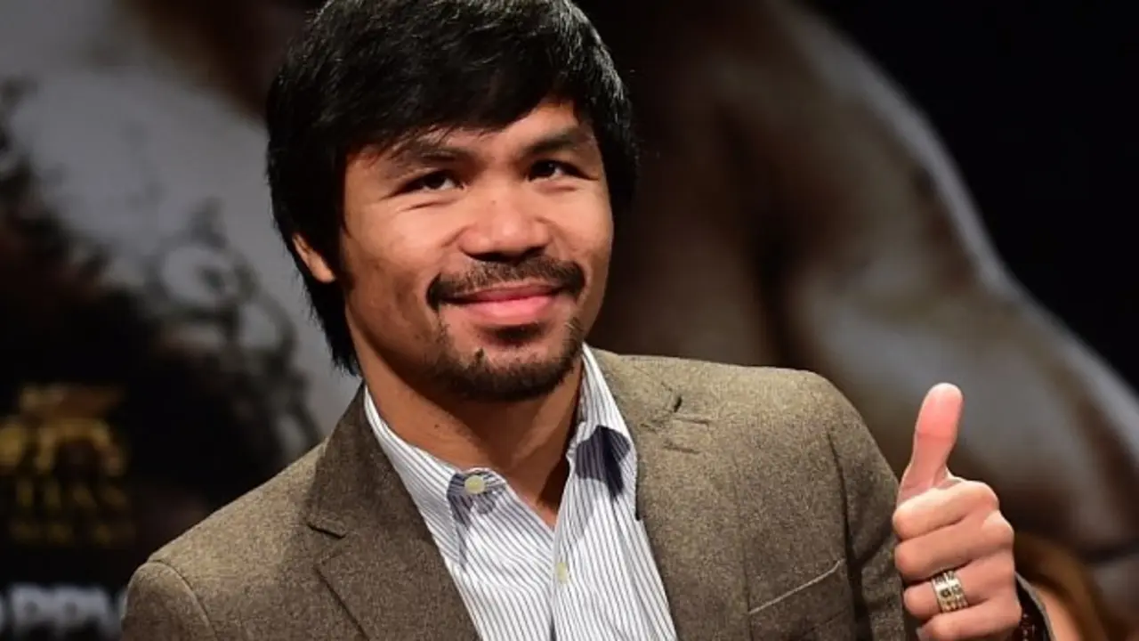 (FILES) In this September 3, 2014 file photo, Filipino boxing star Manny Pacquiao gestures on arrival for a press conference with fellow boxer Chris Algieri in Los Angeles, California. Pacquiao called his boxing showdown with Floyd Mayweather "the fight of my life" as he got down to work pounding the streets and gym in Los Angeles. The eight-division world champion cranked into serious preparations for the May 2 fight after flying in for his training camp from his native Philippines. On March 2, 2015, Pacquiao ran two miles (3.2 km) and shadow-boxed for two rounds, followed by abdominal work and breakfast of steamed rice, scrambled egg, fish and chicken broth. AFP PHOTO / FREDERIC J. BROWN / FILESFREDERIC J. BROWN/AFP/Getty Images