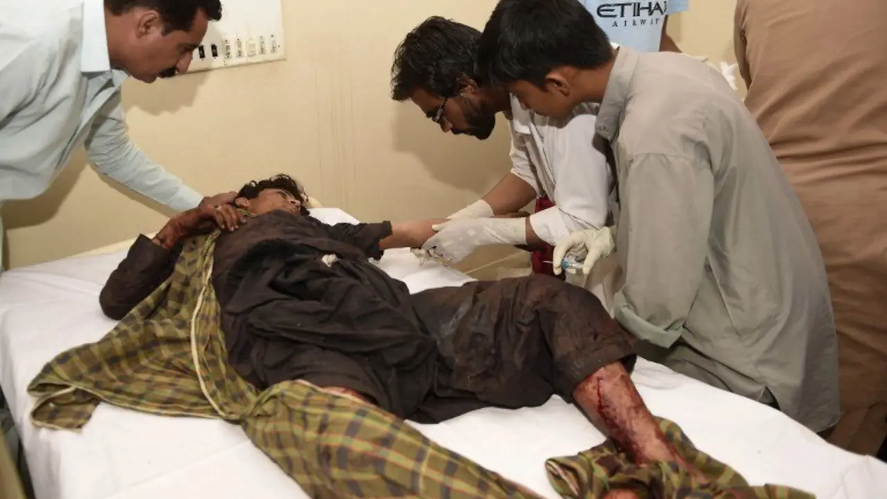 Pakistani paramedics give treatment to an injured blast victim at a hospital in the Hub district, some 40 kilometers from Karachi, on November 12, 2016. 
At least 43 people died and scores of others were injured when a bomb exploded at a remote Sufi shrine in southern Pakistan's restive Balochistan province on November 12, officials said. The blast hit a crowd of worshippers participating in a ceremony at the shrine of Sufi saint Shah Noorani in Khuzdar district, some 760 kilometres south of provincial capital Quetta. / AFP PHOTO / ASIF HASSAN