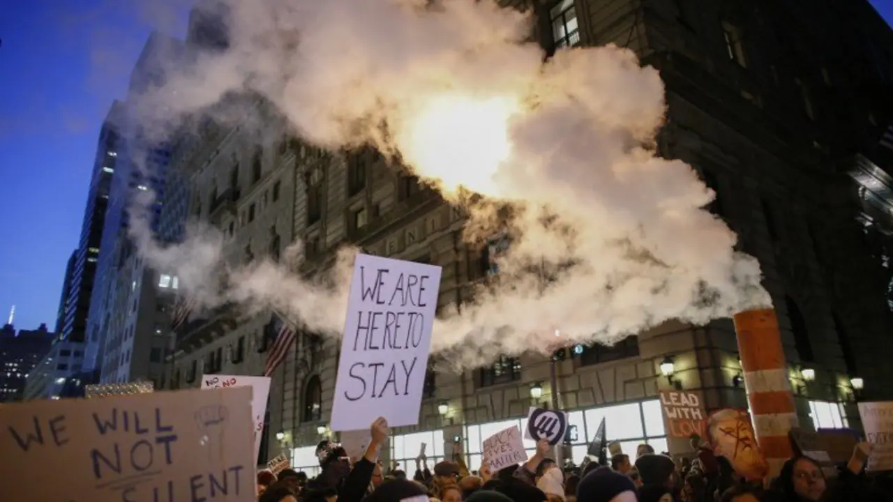 Demonstrators protest against US President-elect Donald Trump in front of Trump Tower on November 12, 2016 in New York. 
Americans spilled into the streets Saturday for a new day of protests against Donald Trump, even as the president-elect appeared to back away from the fiery rhetoric that propelled him to the White House. / AFP PHOTO / KENA BETANCUR
