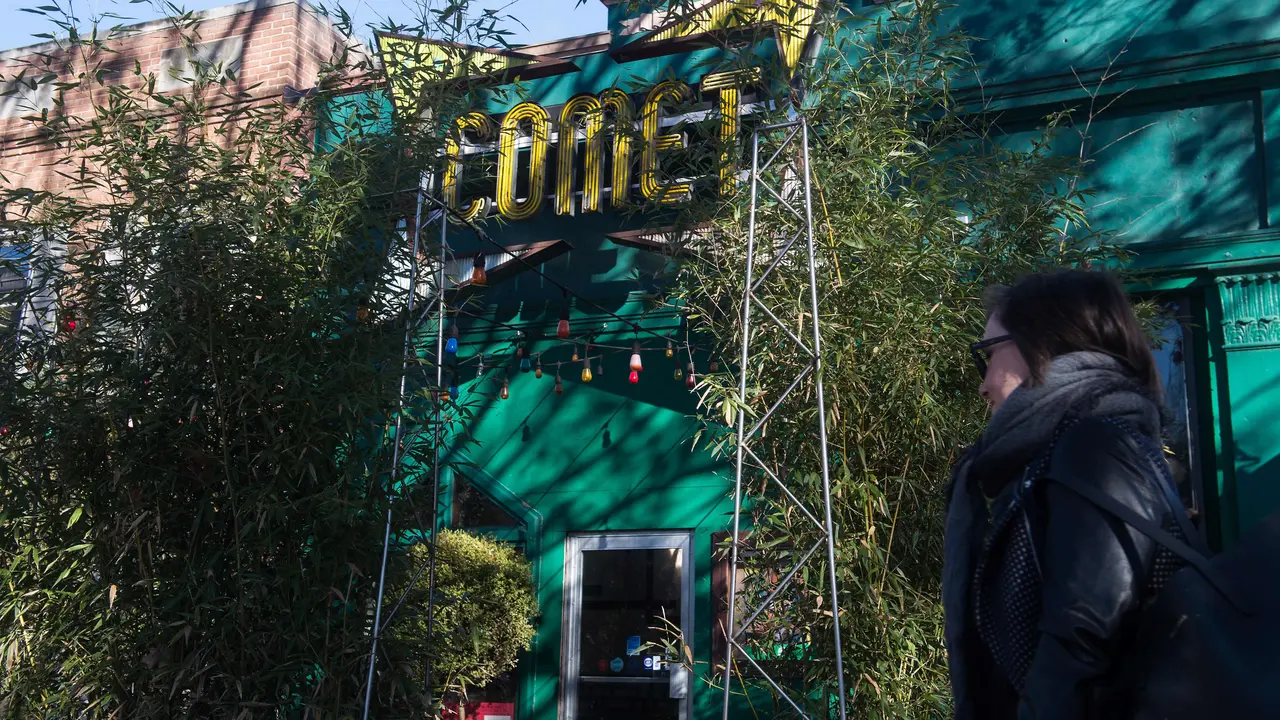 A woman walks past the Comet Ping Pong restaurant in Washingon, DC, on December 5, 2016.
An assault rifle-wielding gunman's appearance at a Washington pizzeria that was falsely reported to house a pedophile ring has elevated worries over the unrelenting rise of fake news and malicious gossip on the internet. No one was injured when 28-year-old Edgar Maddison Welch strode into the Comet Ping Pong restaurant, packed with families on a Sunday afternoon, and fired off a round from his AR-15.
 / AFP PHOTO / NICHOLAS KAMM